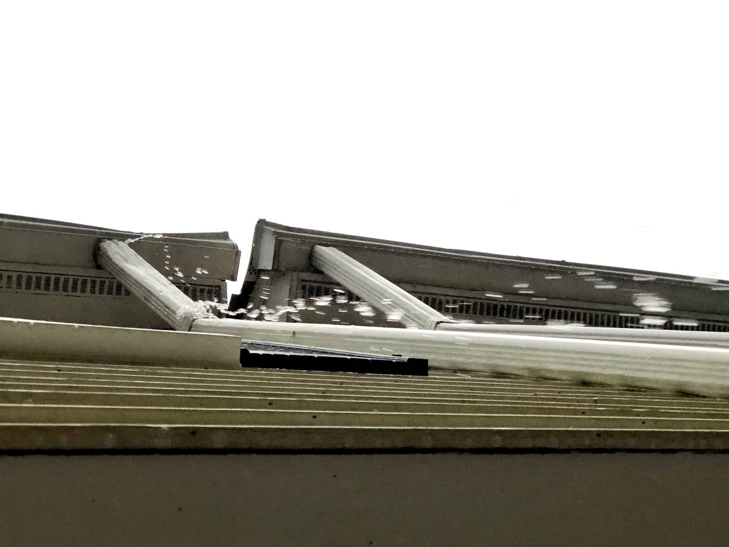 Rain overflowing gutters and downspout