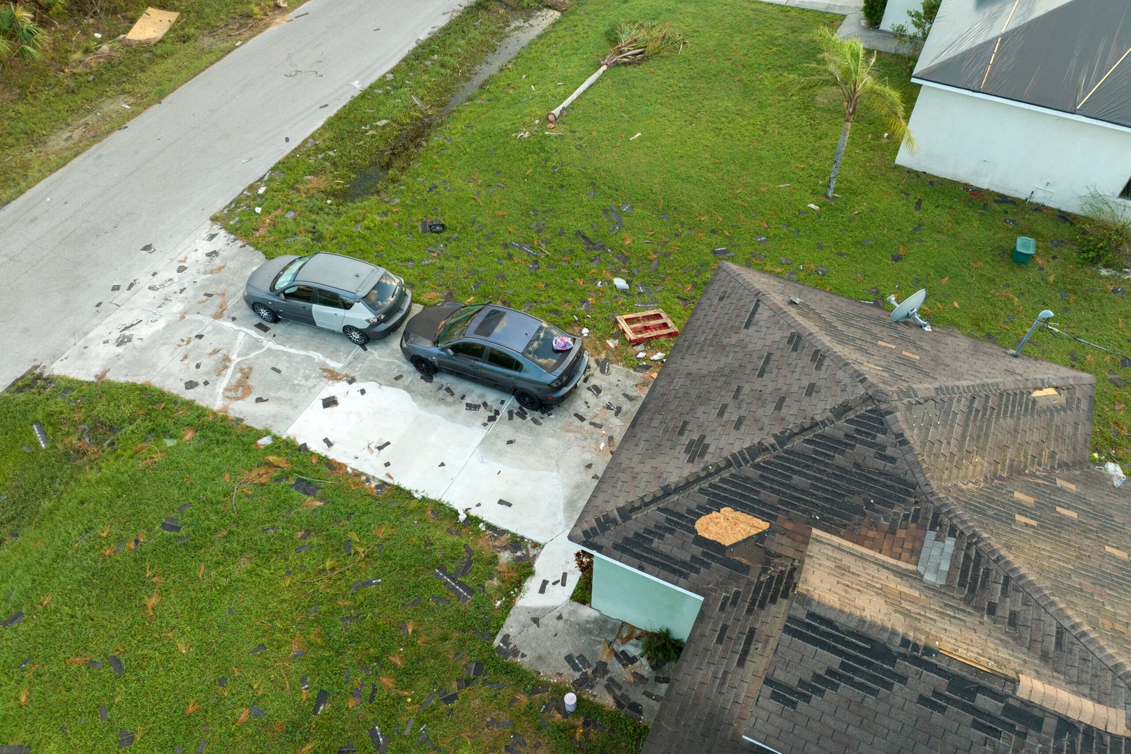 Natural disaster and its consequences. Hurricane Idalia destroyed house roof in Florida residential area.