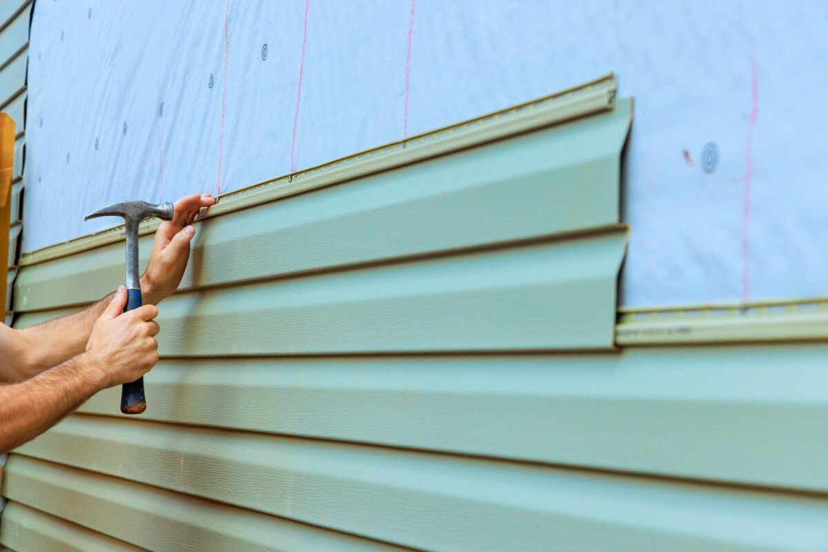 Home improvement project involves installing new siding on an exterior wall with a focus on detail