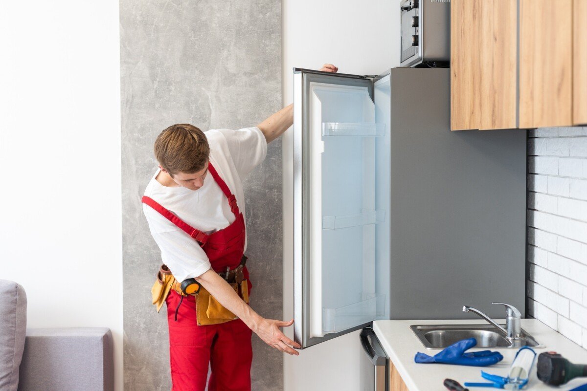 Electrician Technician Working To Repair Refrigerator Or Fridge Appliance