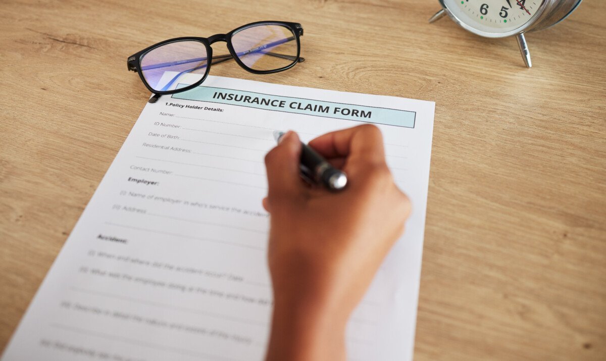 Legal form, hands and person with insurance lawyer and writing with document and paperwork at law f.