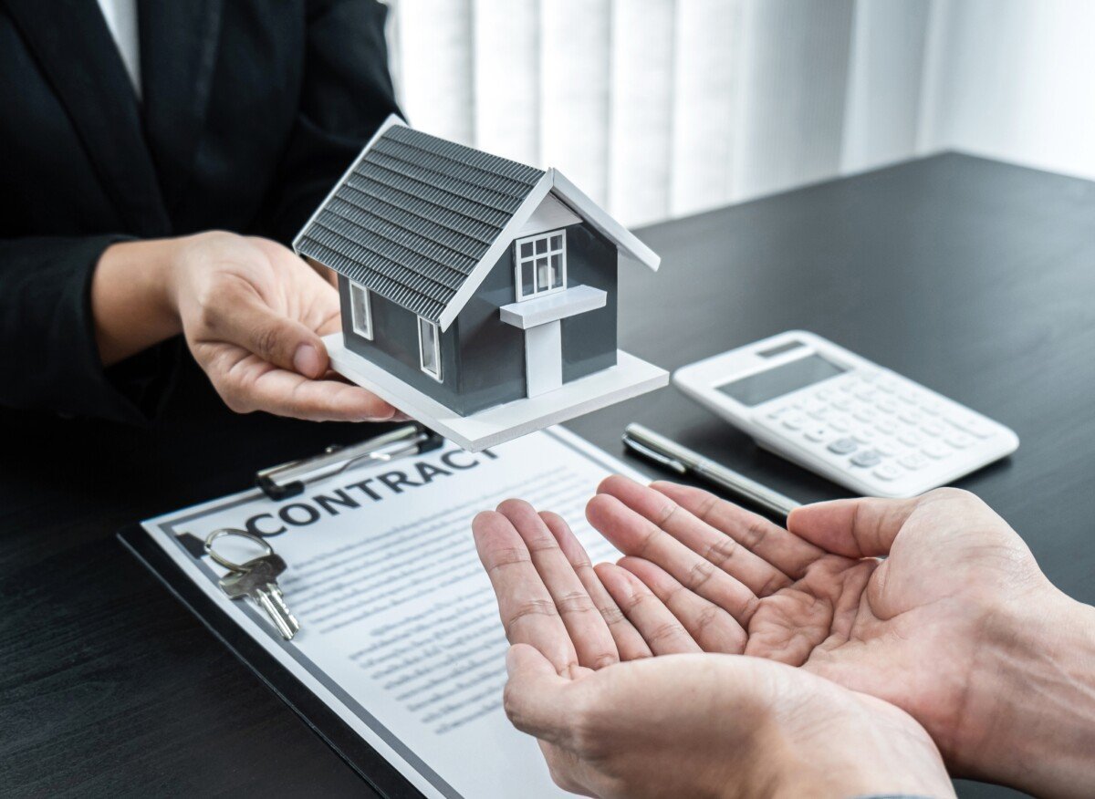 Estate agent giving house and keys to client after signing agreement contract real estate with approved mortgage…
